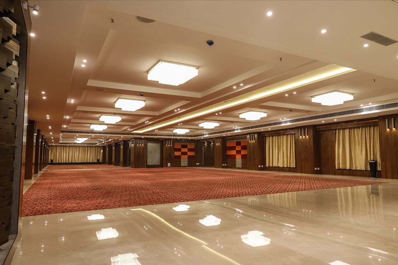 Maharaja banquet hall stretching into the distance with crystal chandeliers and a polished marble border