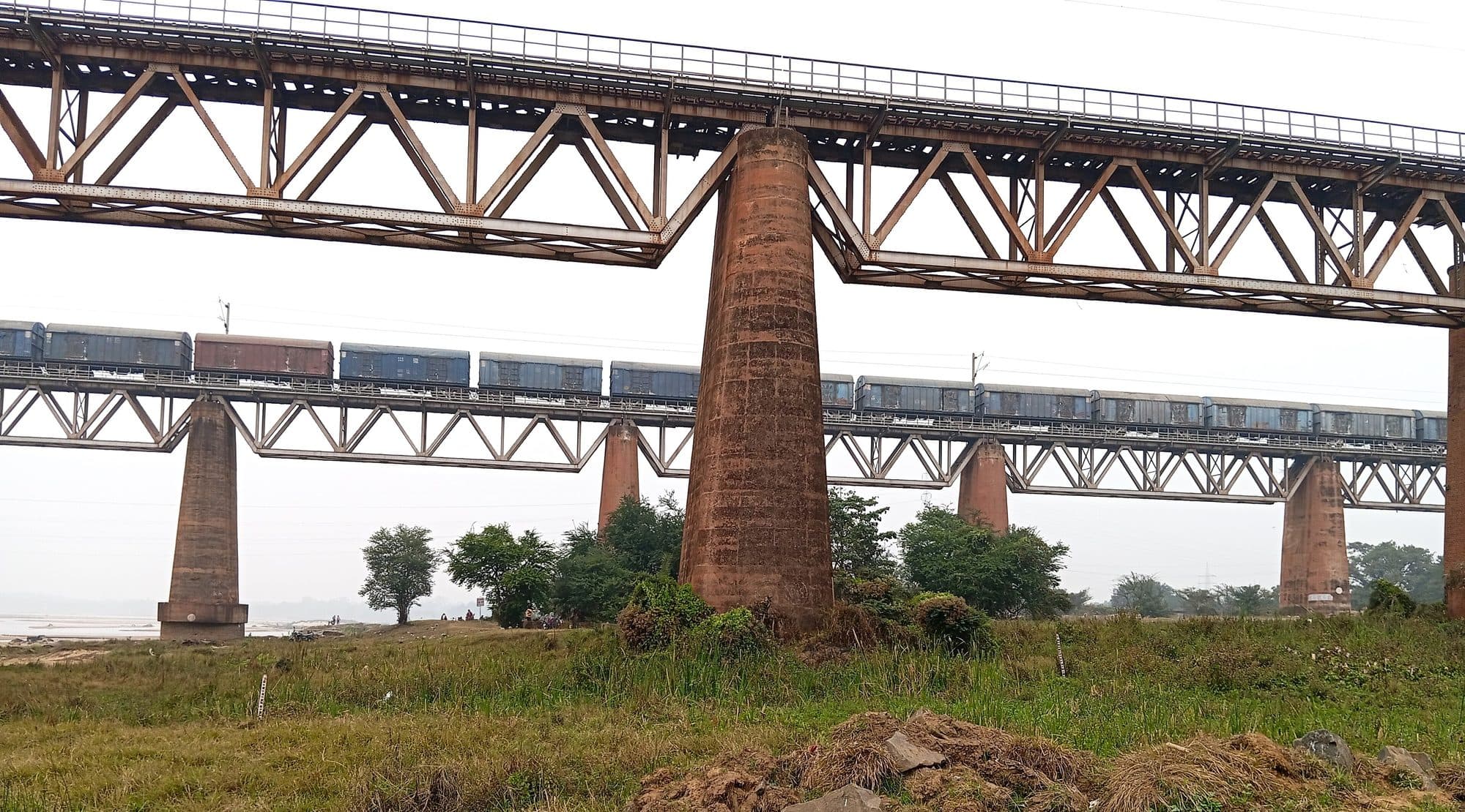 A goods train crossing a steel truss bridge over the Damodar river near Burnpur